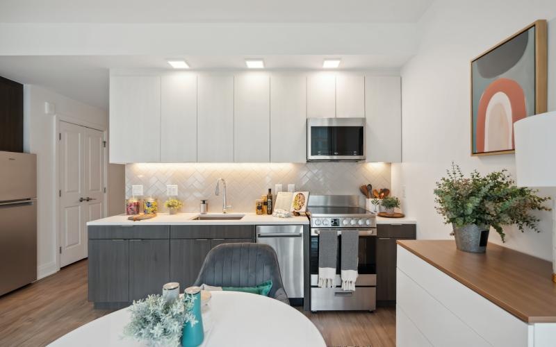 a kitchen with grey cabinets